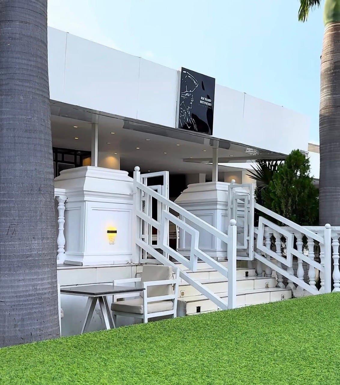 Crush Cafe Abuja — elegant white exterior with palm trees